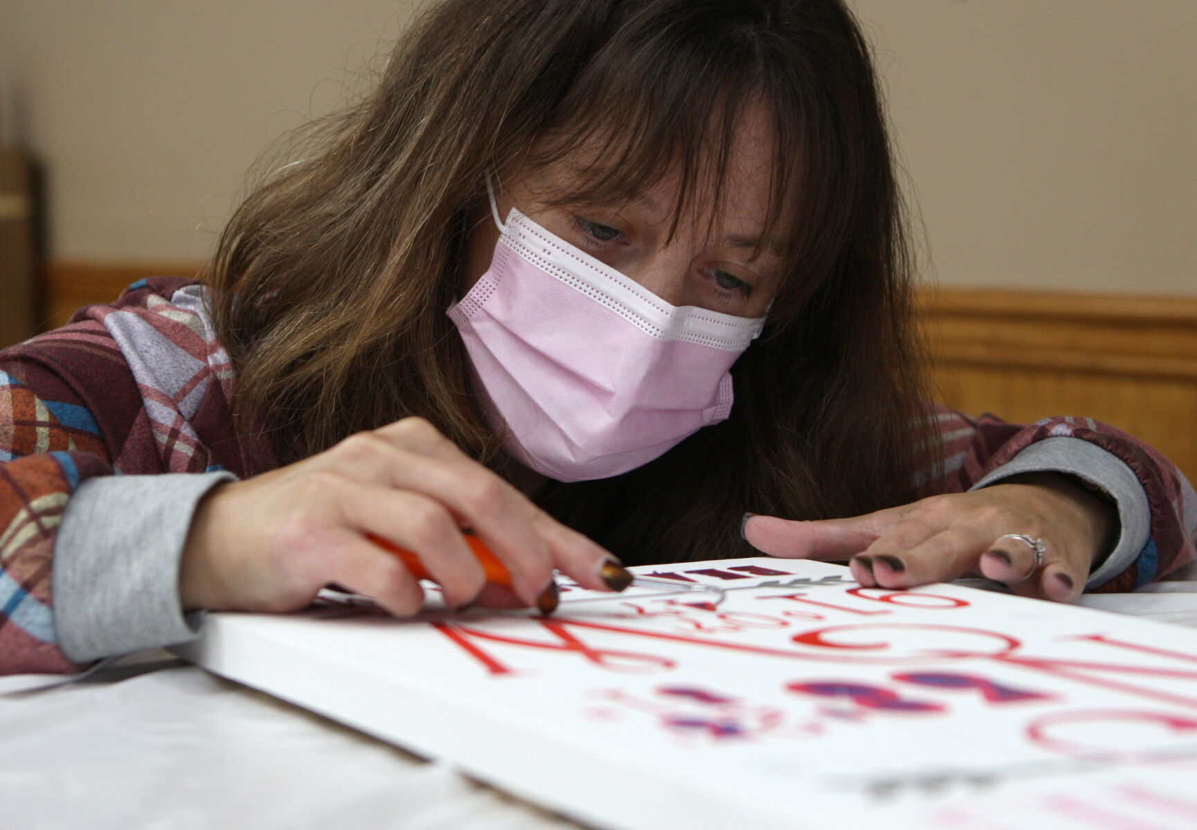 Vicky Jacquin removes a stencil